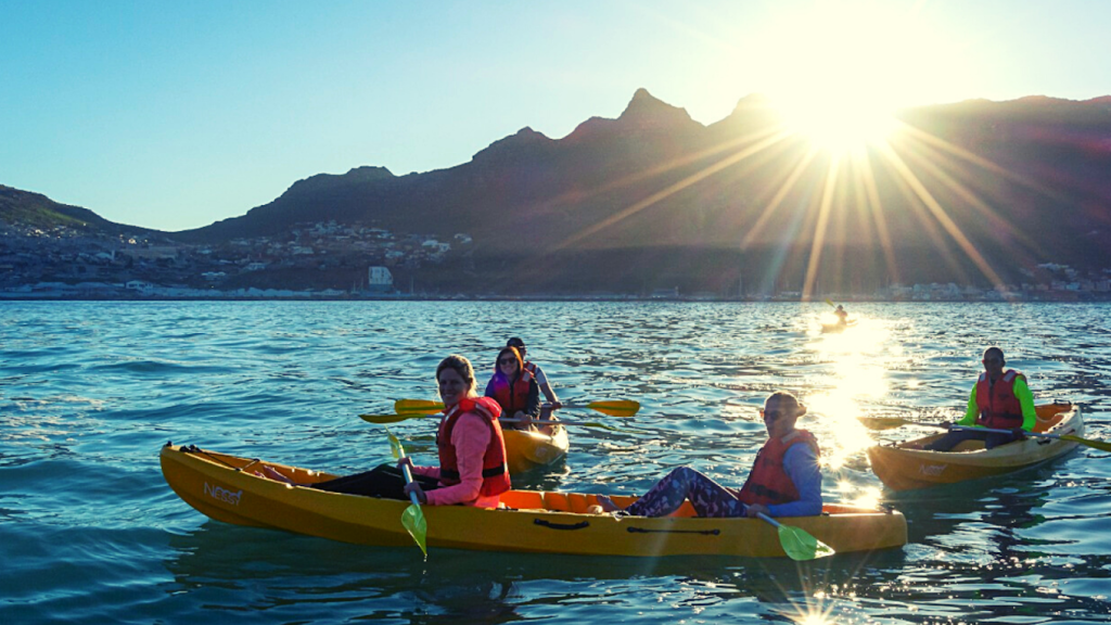 Kayaking activity in Hout Bay at sunset